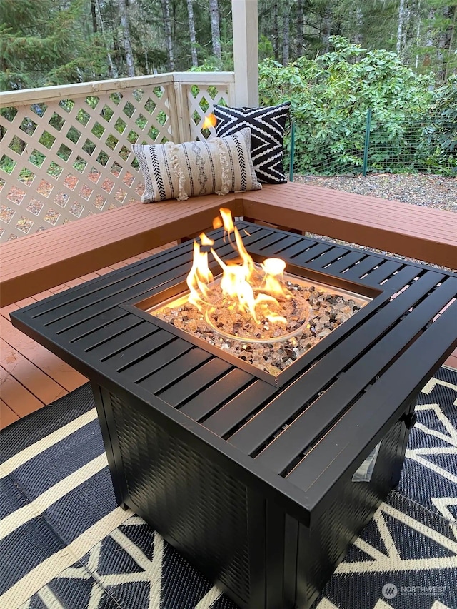 wooden terrace featuring an outdoor fire pit