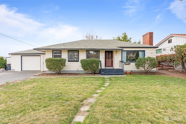 single story home with a garage and a front lawn