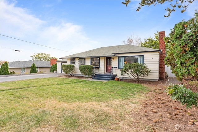 ranch-style home with a front yard and a garage