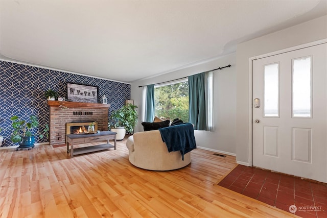 351 Mocliff Rd, Ephrata, WA 98823 - living room featuring wood finished floors, visible vents, an accent wall, baseboards, and a fireplace
