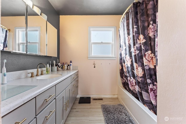 351 Mocliff Rd, Ephrata, WA 98823 - bathroom featuring wood finished floors, visible vents, vanity, shower / tub combo with curtain, and baseboards