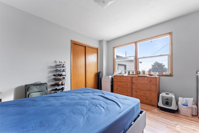 bedroom featuring a closet and light hardwood / wood-style flooring