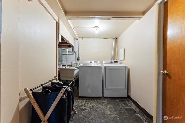 washroom with separate washer and dryer and sink