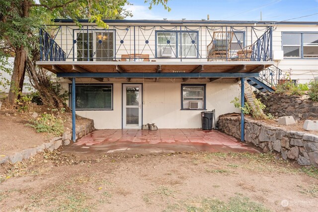 back of house featuring a balcony and a patio area