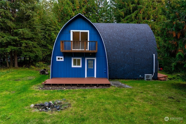 view of outbuilding featuring central air condition unit and a yard