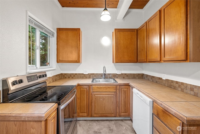 kitchen with white dishwasher, stainless steel electric stove, and tile countertops