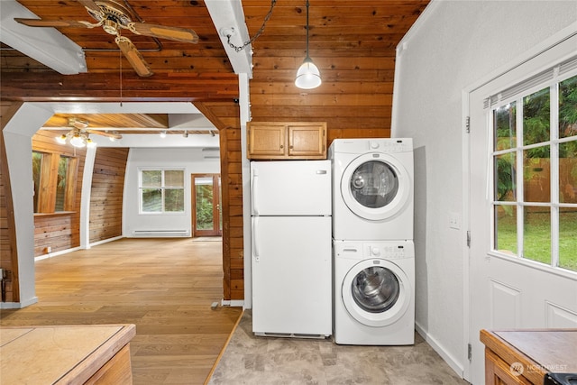 laundry room with wooden ceiling, light wood-type flooring, stacked washer / dryer, and wooden walls