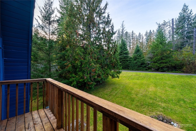 wooden terrace featuring a yard