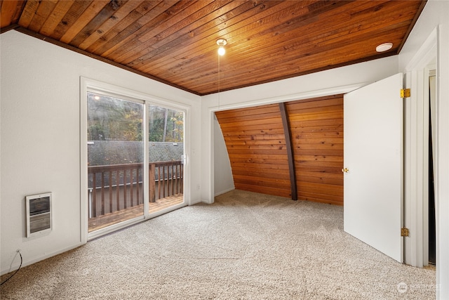 empty room with lofted ceiling, wood ceiling, and carpet flooring