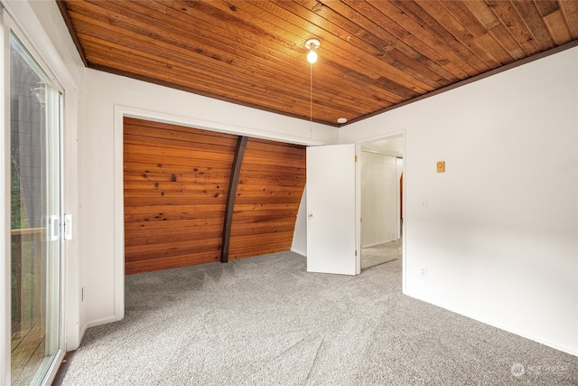 unfurnished bedroom with wooden ceiling and carpet