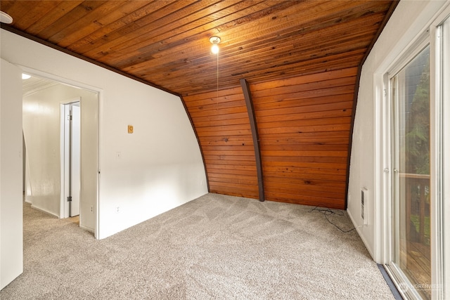 spare room featuring light carpet, lofted ceiling, and wooden ceiling