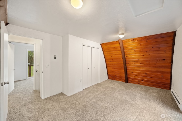 unfurnished bedroom with a closet and light colored carpet