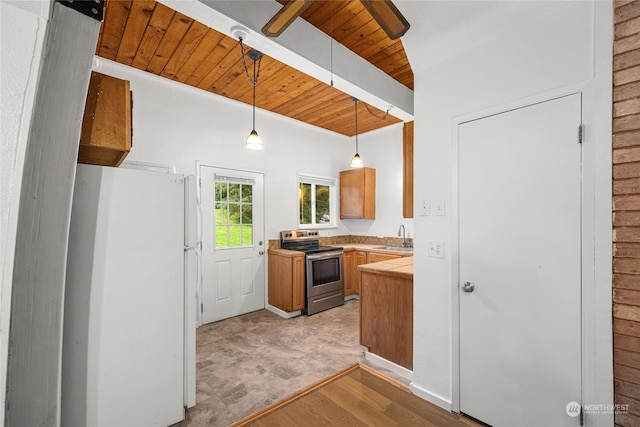kitchen featuring a sink, light countertops, stainless steel range with electric stovetop, freestanding refrigerator, and wooden ceiling