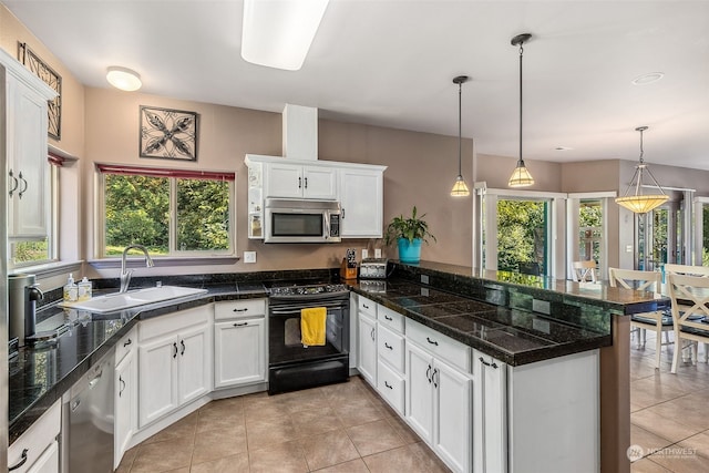 kitchen with white cabinets, hanging light fixtures, sink, kitchen peninsula, and appliances with stainless steel finishes