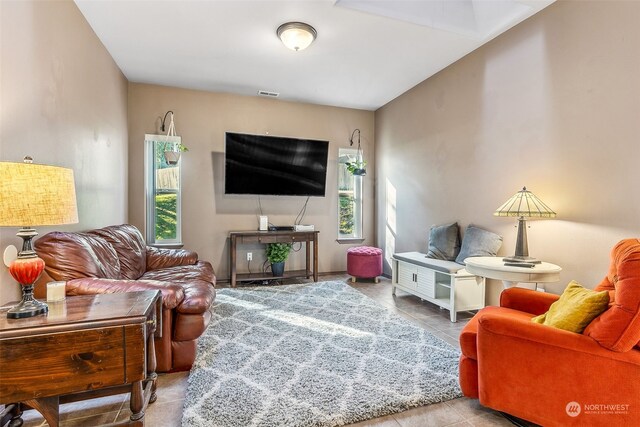 tiled living room with a healthy amount of sunlight