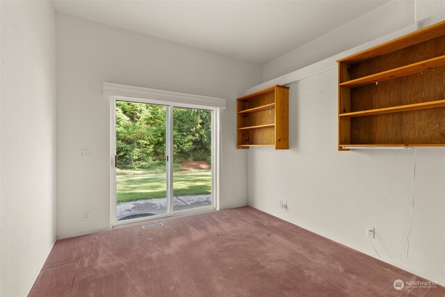 spare room featuring carpet floors and visible vents