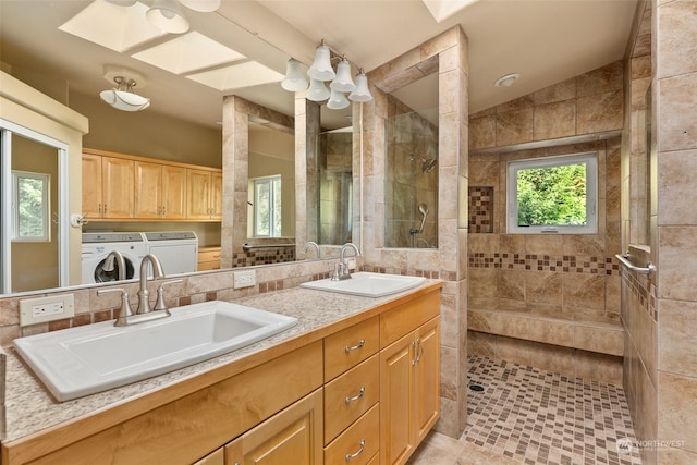 full bathroom featuring a sink, a walk in shower, and washing machine and dryer