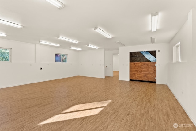 spare room with light wood-style flooring and baseboards