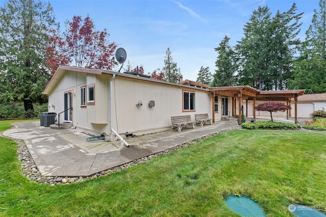 back of property with cooling unit, a lawn, and a patio