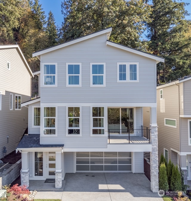 rear view of property with a garage