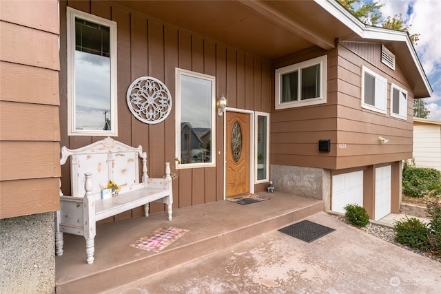 view of exterior entry with an attached garage