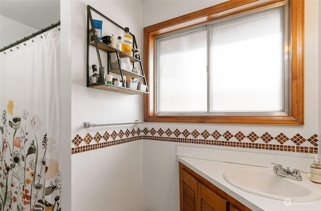 full bath featuring vanity, a shower with curtain, and tile walls