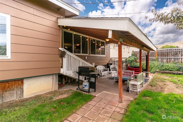 view of patio / terrace featuring an outdoor living space and fence
