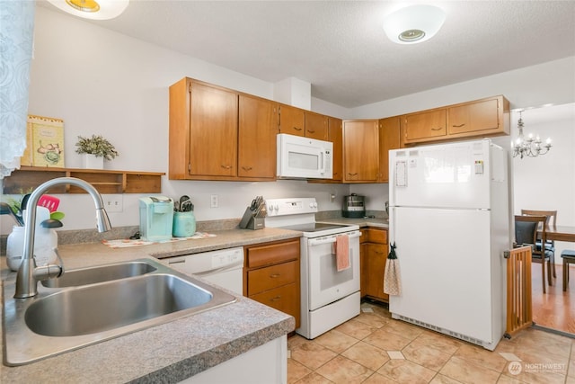 kitchen with pendant lighting, sink, white appliances, a textured ceiling, and an inviting chandelier