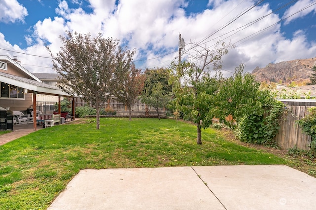 view of yard with a mountain view and a patio area