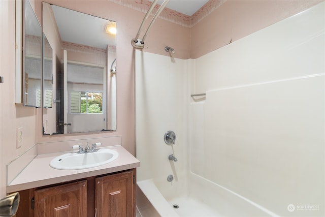 bathroom with vanity and bathing tub / shower combination