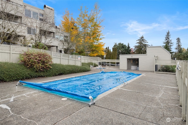 view of swimming pool featuring a patio area