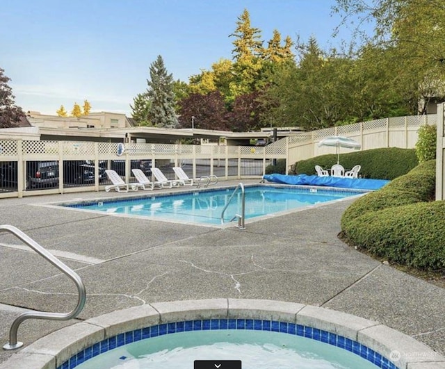 view of swimming pool featuring a community hot tub