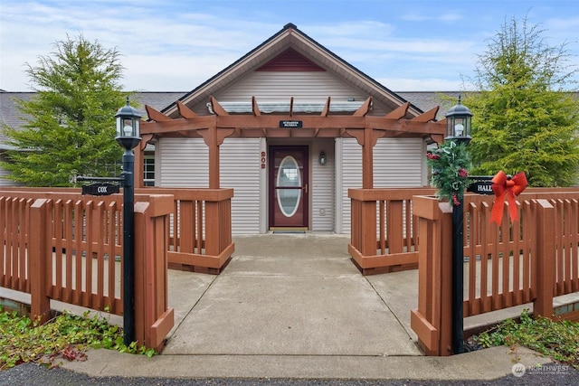 view of front of property featuring a patio area and a pergola