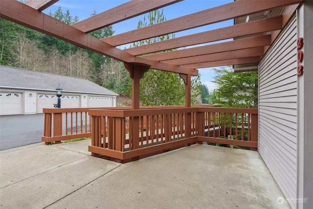 view of patio with a pergola and a garage