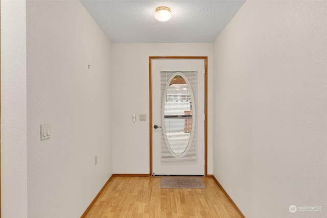 entryway featuring light hardwood / wood-style floors and a textured ceiling