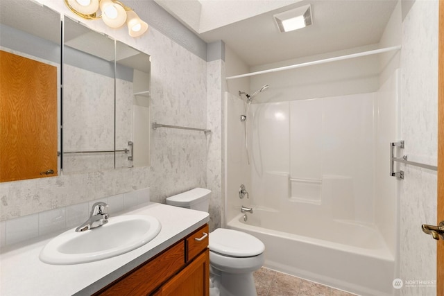 full bathroom with vanity, tub / shower combination, and toilet