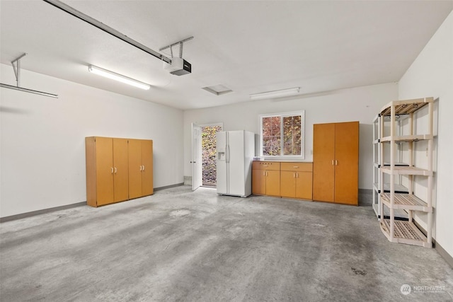 garage with white refrigerator with ice dispenser and a garage door opener