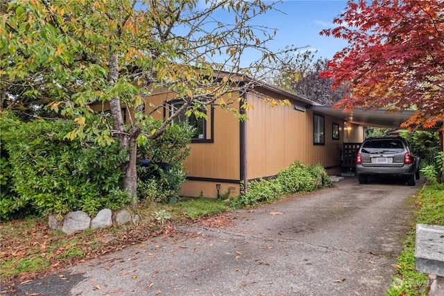 view of side of home with a carport