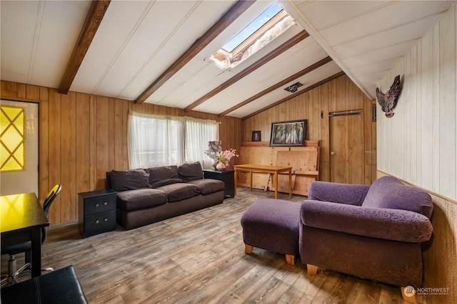 living room featuring hardwood / wood-style flooring, wooden walls, and lofted ceiling with skylight