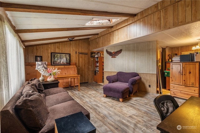 living room with wooden walls, hardwood / wood-style floors, and lofted ceiling with skylight