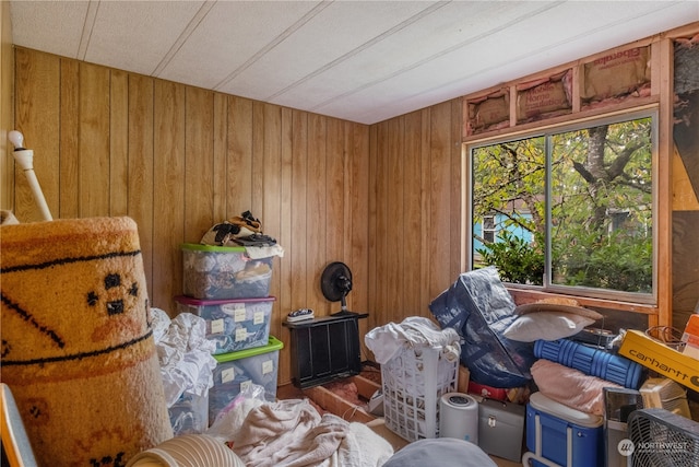 misc room featuring wood walls