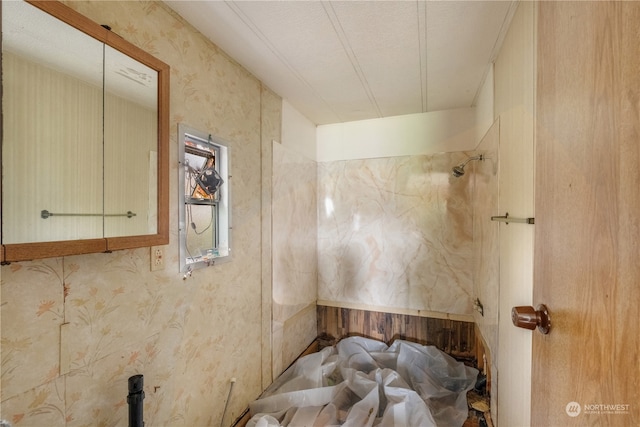 bathroom featuring a textured ceiling and a shower