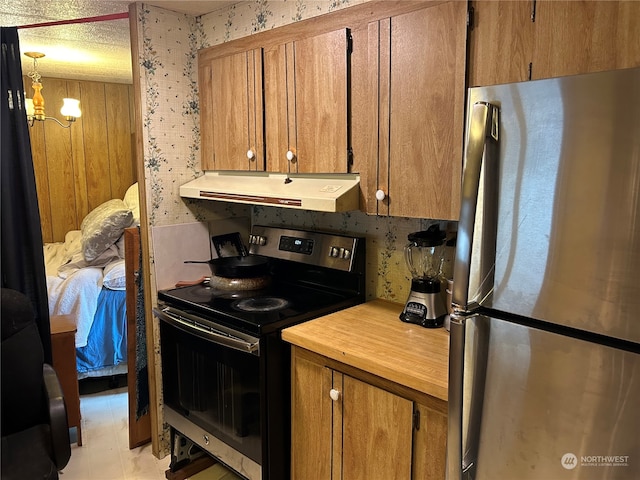 kitchen featuring appliances with stainless steel finishes and a chandelier