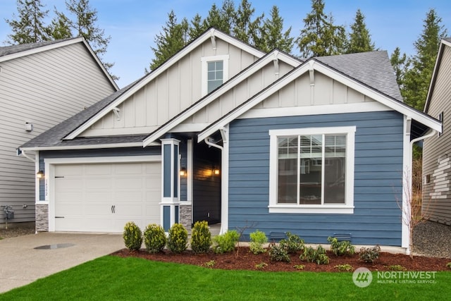 craftsman house with a front yard and a garage