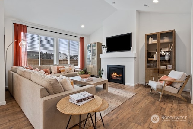 living room with hardwood / wood-style flooring and lofted ceiling