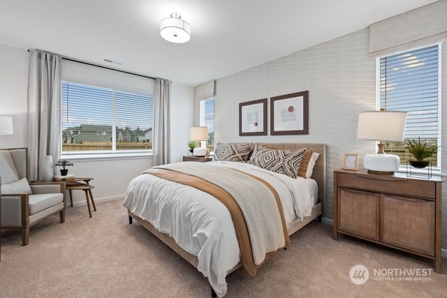 bedroom featuring light colored carpet and vaulted ceiling