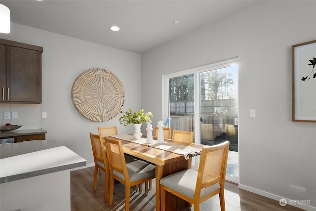 dining space with dark hardwood / wood-style floors