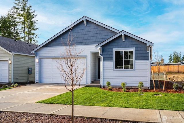 view of front of home with a garage and a front lawn