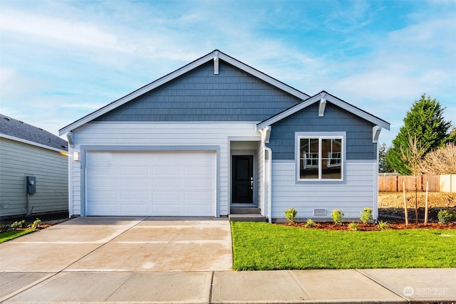 view of front of property featuring a garage and a front yard