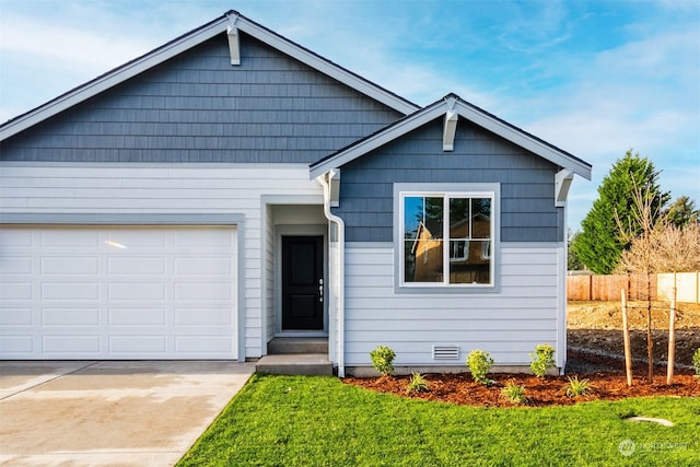 view of front of property featuring a garage and a front yard